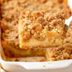 Pumpkin French Toast Casserole 5 Golden baked pumpkin french toast casserole with crumb topping in a white baking dish