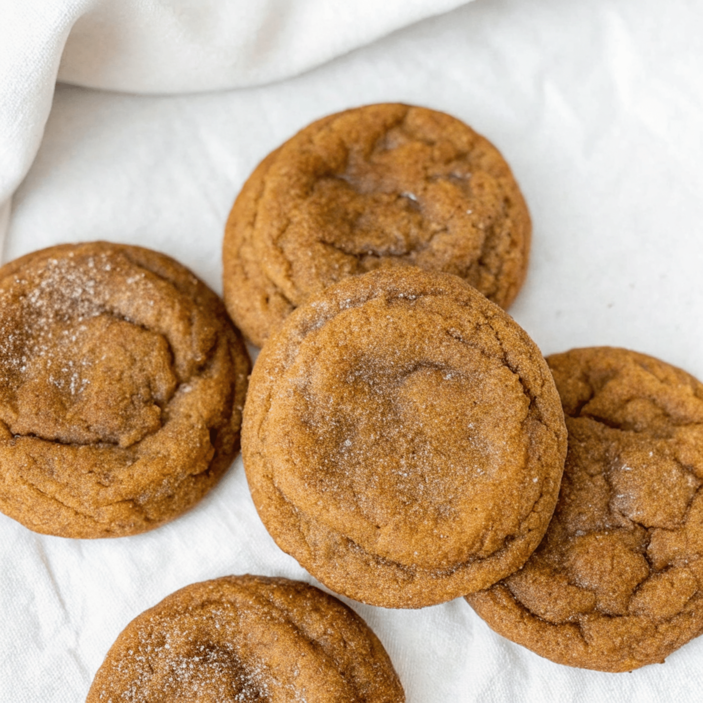 Stack of brown butter pumpkin snickerdoodle cookies with cinnamon sugar coating on white plate