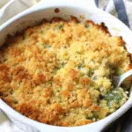 Easy Cheesy Zucchini Casserole 10 Golden brown cheesy zucchini casserole in white baking dish with melted cheddar cheese on top