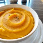 Gordon Ramsay Butternut Squash Soup 5 gordon ramsay butternut squash soup in a white bowl garnished with fresh sage leaves and a drizzle of olive oil, served alongside crusty bread on a rustic wooden table