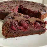 Irresistible Chocolate Cherry Upside Down Cake 8 Chocolate cherry upside down cake on white plate showing glossy red cherries on top of rich chocolate cake with optional chocolate ganache drizzle