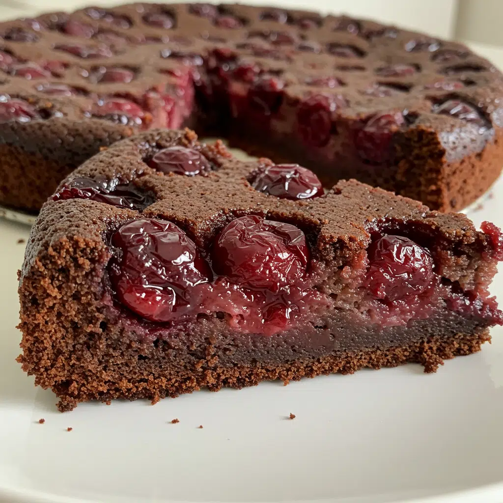 Irresistible Chocolate Cherry Upside Down Cake 7 Chocolate cherry upside down cake on white plate showing glossy red cherries on top of rich chocolate cake with optional chocolate ganache drizzle
