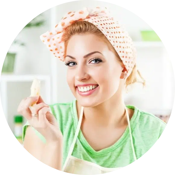 Home Page 1 Smiling woman in a retro-style headscarf holding a banana in a cozy kitchen, ready to cook