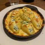 Seafood Stuffed Shells 6 Baked seafood stuffed shells with golden breadcrumb topping in casserole dish