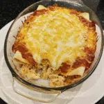Chicken Enchiladas with Sour Cream White Sauce 6 Golden bubbly chicken enchiladas with creamy white sauce and melted cheese in a 9x13 baking dish straight from the oven