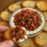This addictive bruschetta dip turns classic Italian flavors into the perfect party appetizer that disappears in minutes!