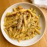 Garlic Parmesan Chicken Pasta 5 Homemade one-pan garlic parmesan chicken pasta in a cast iron skillet with sliced seasoned chicken over creamy penne pasta, garnished with fresh parsley