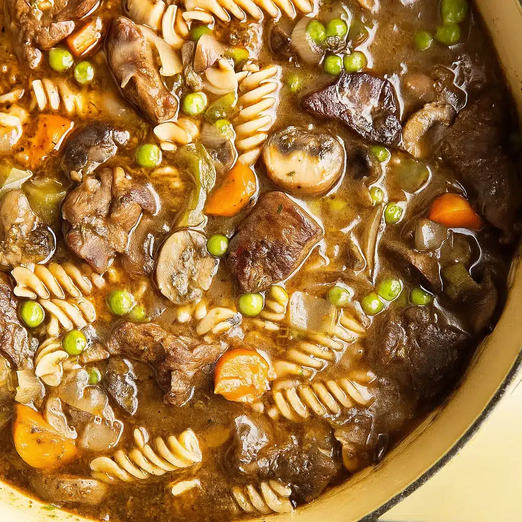 Beef Stew and Noodles 4 A steaming bowl of homemade beef stew and noodles with tender beef chunks, vegetables, and egg noodles in a rich brown broth, garnished with fresh parsley