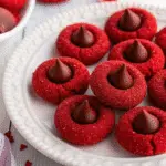 Hershey's Red Velvet Blossoms Cookies are the perfect festive treat! Soft, buttery red velvet cookies rolled in sparkly red sugar and topped with chocolate Kisses – ready in just 25 minutes