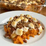 Southern Maple Sweet Potato Casserole is everything you love about the holidays in one dish! Roasted sweet potatoes, warm spices, plump raisins, gooey marshmallows, and a crunchy maple pecan topping make this the ultimate comfort food side dish