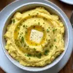 Creamy Yukon Gold Mashed Potatoes with a tangy twist from Greek yogurt—buttery, fluffy, and ready in 30 minutes! The perfect comfort food side dish.