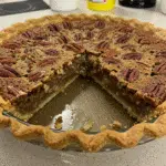 Pecan Pie Cobbler has a golden, slightly crispy top with a gooey, caramel-pecan filling underneath—all the flavor of pecan pie without the fussy crust!