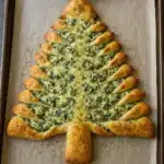 Christmas Tree Spinach Dip Breadsticks are the ultimate holiday party appetizer! Cheesy spinach filling wrapped in golden pizza dough and shaped into a festive pull-apart tree.