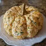 This Pumpkin Shaped Cheese Ball is the cutest fall appetizer ever! Creamy, cheesy, loaded with ranch flavor, and shaped like an adorable pumpkin. Perfect for Halloween parties and Thanksgiving gatherings