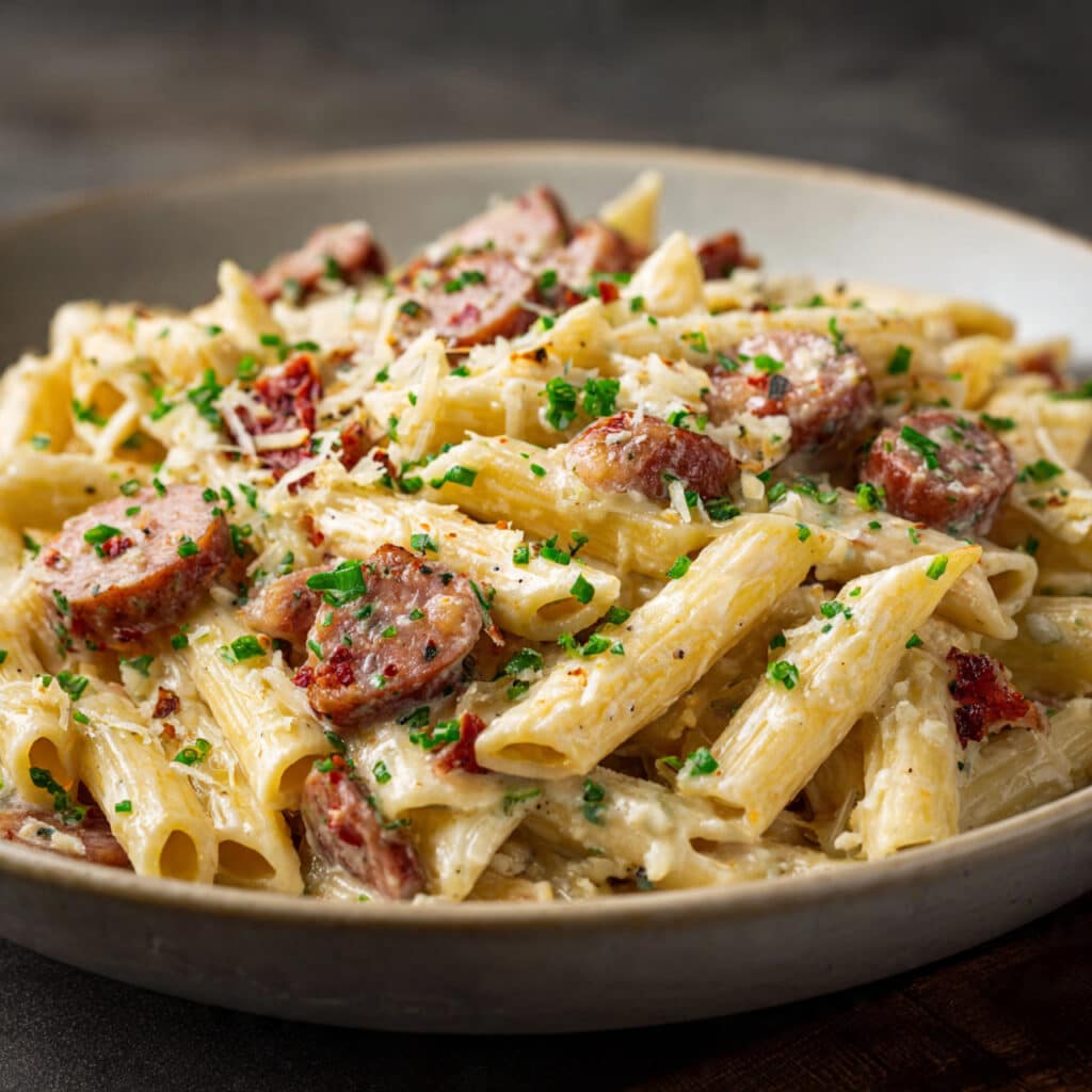 Creamy Kielbasa Pasta comes together in under 30 minutes with simple ingredients! Smoky kielbasa, tender pasta, and the most incredible cheesy sauce