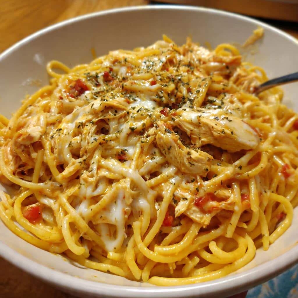 Chicken Spaghetti: The Cheesy, Creamy Casserole Everyone Begs For 4 golden casserole of chicken spaghetti with melted sharp cheddar cheese on top, fresh from the oven in a rectangular baking dish