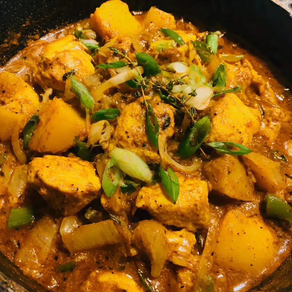 One Pot Jamaican Curry Chicken with juicy chicken thighs, soft potatoes, and thick curry gravy made in one pot for easy cleanup and incredible flavor!