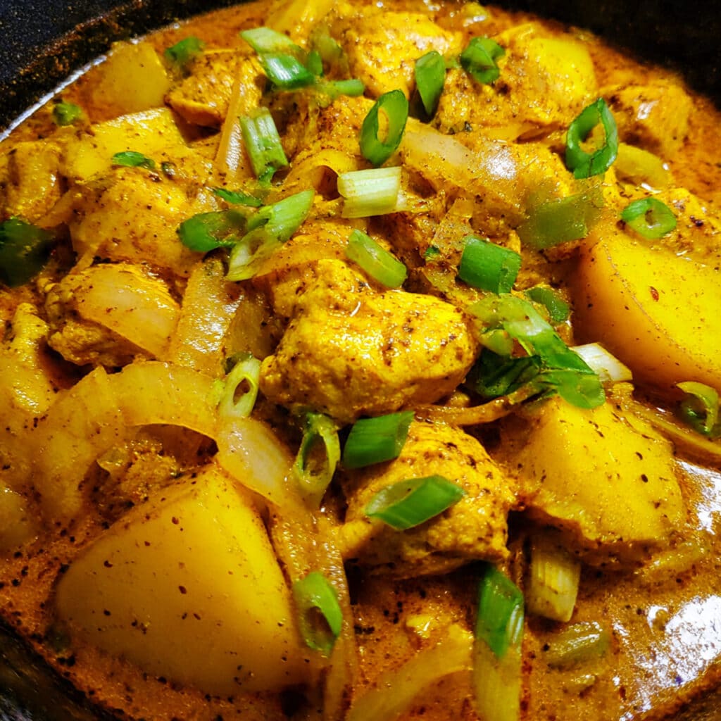 One Pot Jamaican Curry Chicken with juicy chicken thighs, soft potatoes, and thick curry gravy made in one pot for easy cleanup and incredible flavor!