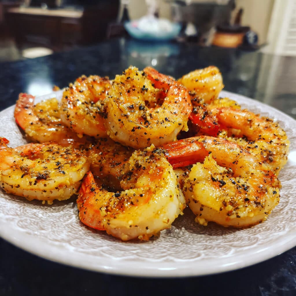Crispy salt and pepper shrimp garnished with sliced chilies and green onions.