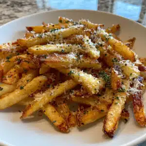 Crispy truffle fries sprinkled with parmesan and fresh herbs