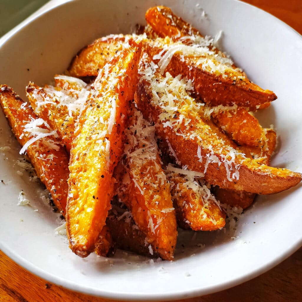 Crispy Garlic Parmesan Sweet Potato Wedges – the perfect savory side dish or snack! Golden, cheesy, and ready in 30 minutes.
