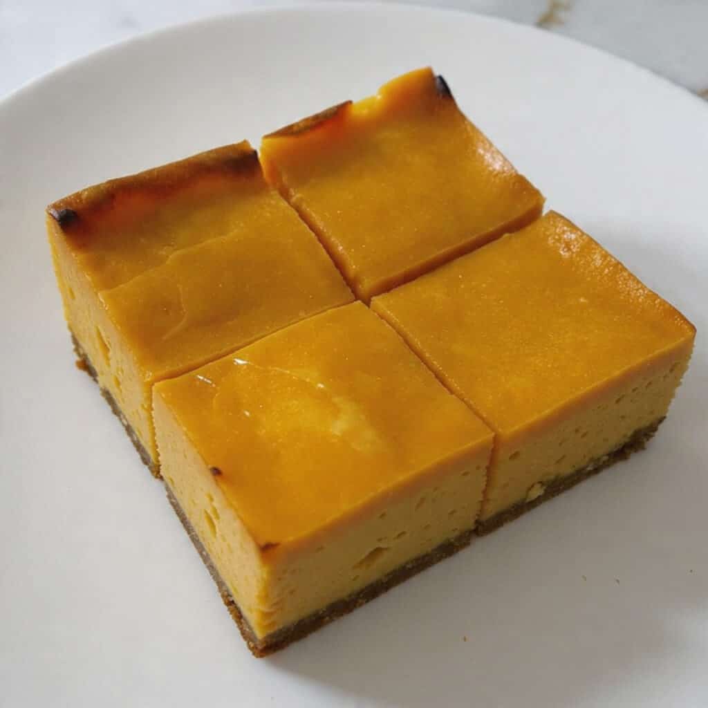 no-bake Sweet Potato Cheesecake Squares feature three beautiful layers: buttery graham cracker crust, silky cheesecake, and spiced sweet potato perfection