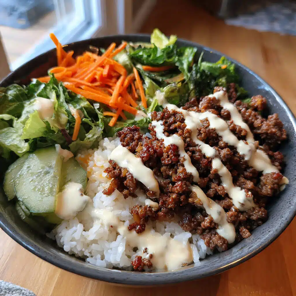 Cozy Korean ground beef bowl with fluffy white rice, garnished with fresh green onions and toasted sesame seeds in a rustic ceramic bowl