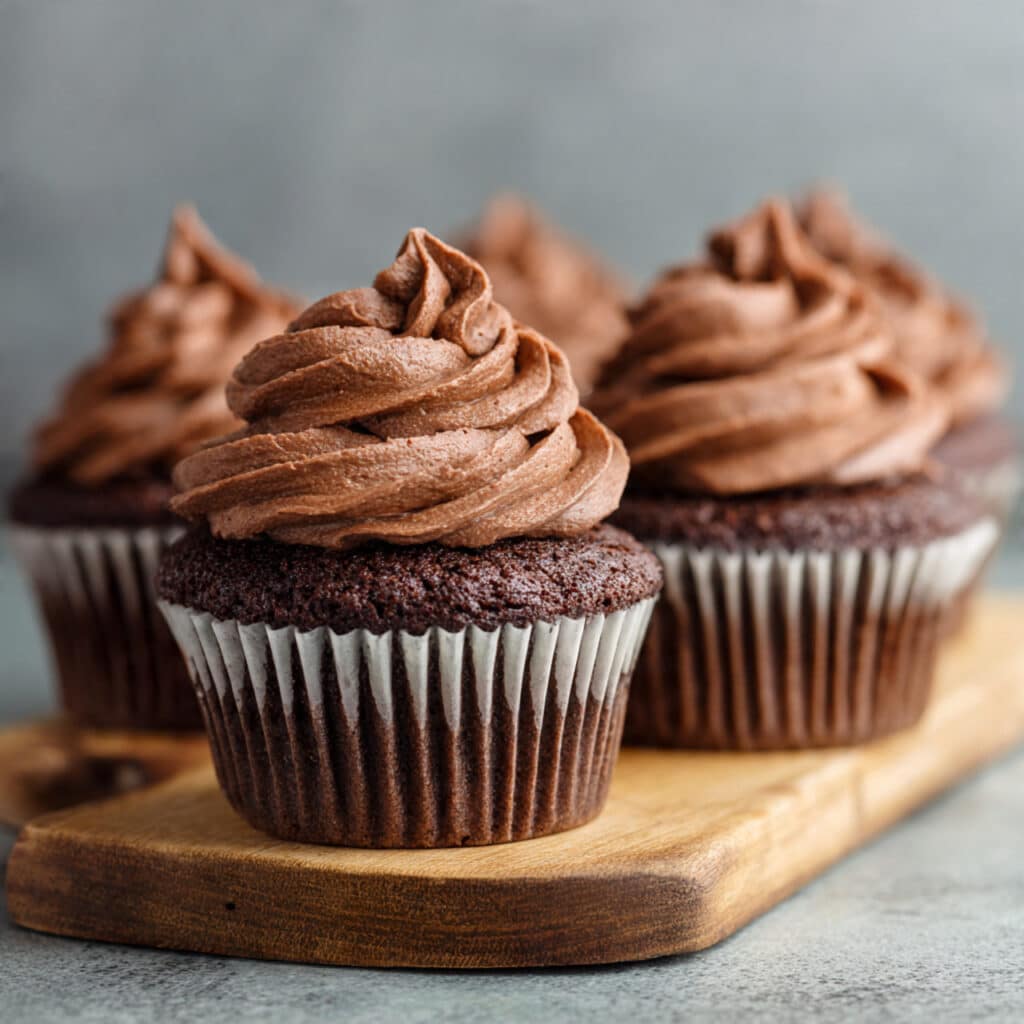 Moist chocolate cupcakes with rich chocolate buttercream frosting and colorful sprinkles on top