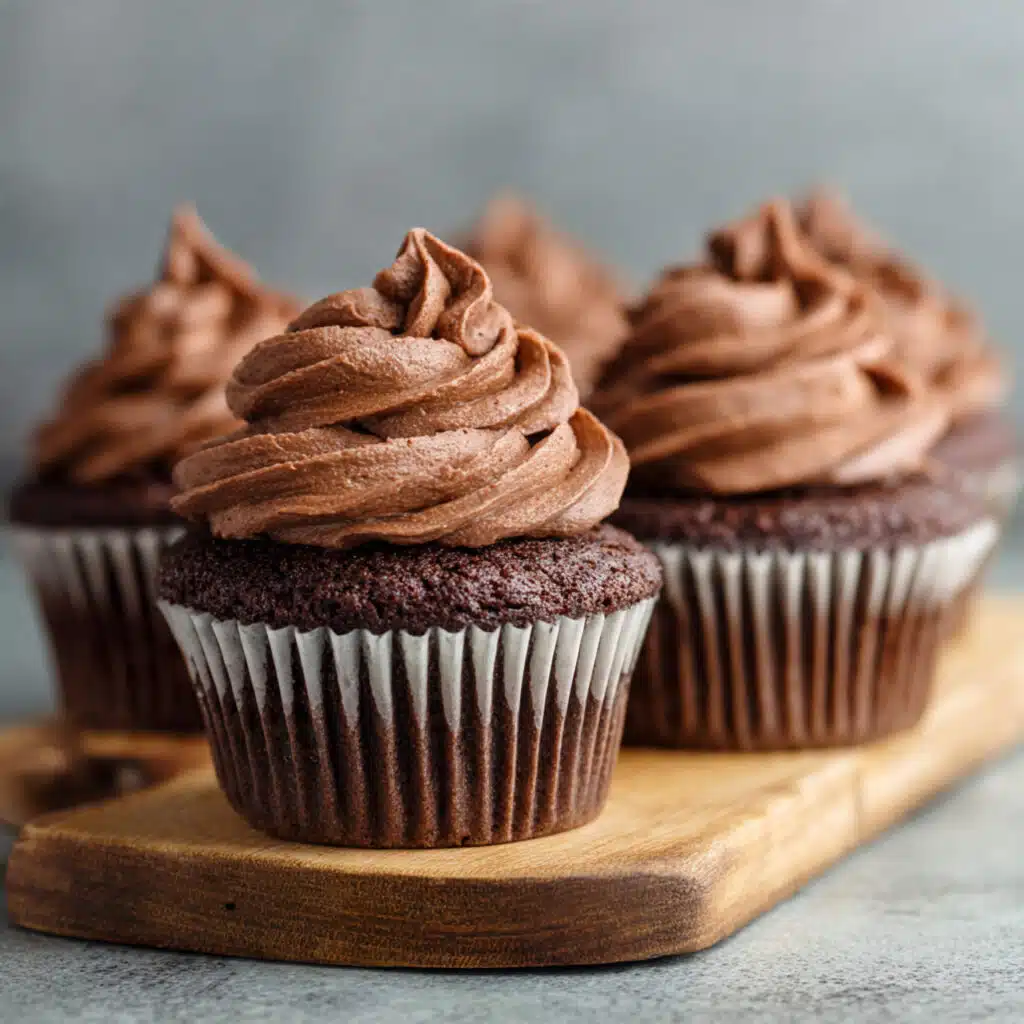 Moist chocolate cupcakes with rich chocolate buttercream frosting and colorful sprinkles on top