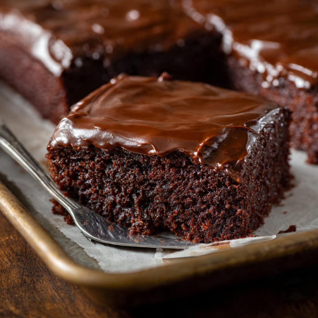Texas Sheet Cake topped with warm chocolate frostin