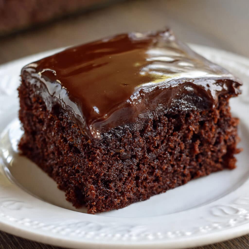 Texas Sheet Cake topped with warm chocolate frostin