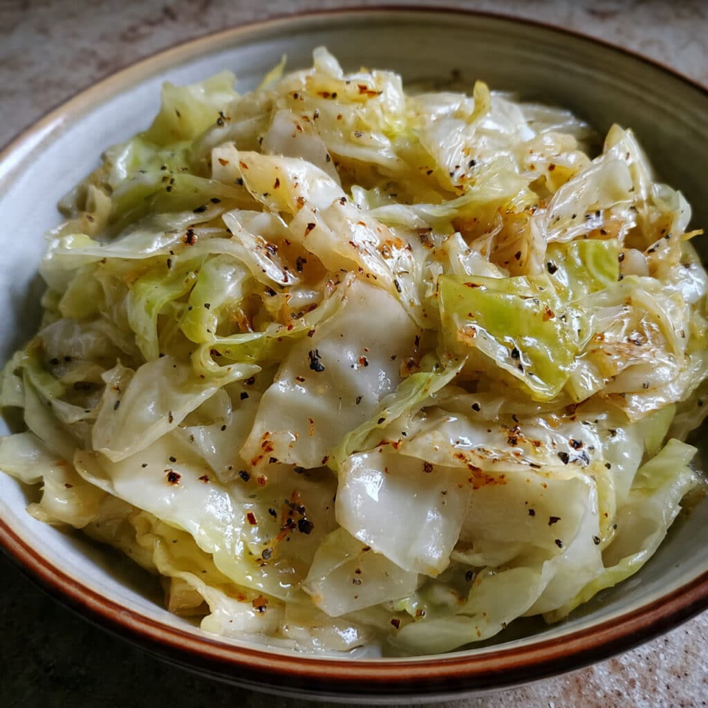 warming Braised Cabbage with butter, onions, and caraway seeds—the ultimate comfort food side dish