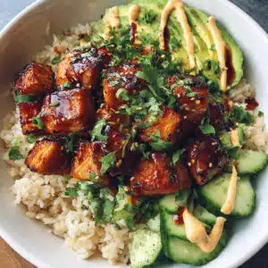 Easy Honey Glazed Salmon Rice Bowls with creamy avocado, crisp cucumber, and smoky paprika-mayo sauce—ready in under 30 minutes