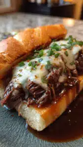 Slow Cooker French Dip Sandwiches you'll ever make! Just let your slow cooker do all the work while the beef becomes fall-apart tender and the broth turns into the most flavorful au jus