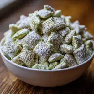 Addictive Pistachio Puppy Chow – the perfect no-bake sweet snack that's ready in 15 minutes! Creamy pistachio flavor meets crunchy cereal for an irresistible treat.